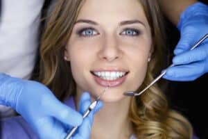 A woman smiling while getting dental implants in Oakton, VA