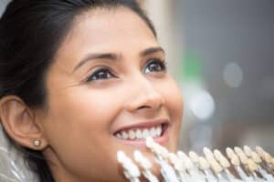 Smiling woman in Oakton, VA, considering porcelain veneers to enhance her smile