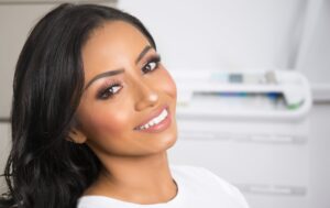 A woman smiling after getting white fillings in Oakton, VA