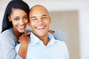 A man and woman smiling and showing the results of dental bonding in Oakton, VA