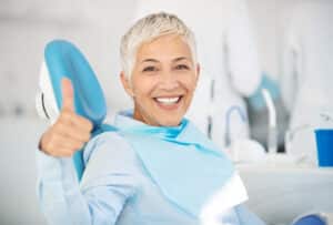 A woman giving a thumb's up after sedation dentistry in Oakton