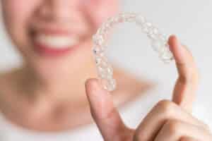 A close-up shot of an Invisalign® aligner